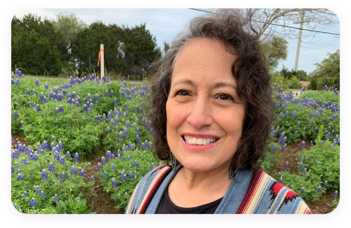 Leandra Sanchez standing in field of bluebonnets