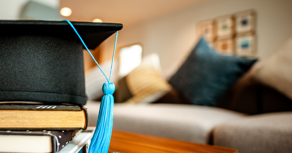 A graduation cap sits on a coffee table in a living room