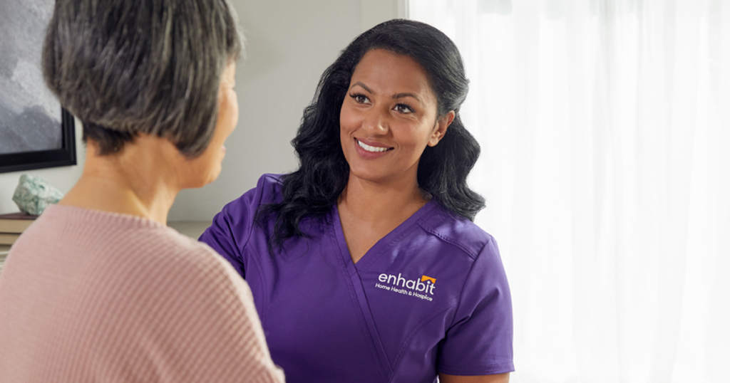 A home health cllinician at Enhabit is working with a patient to demonstrate a career in home health