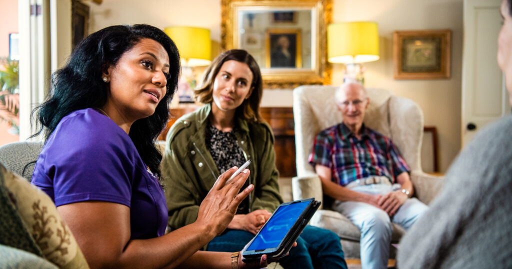 It is indicative of a high-quality home health provider when they offer support and services outside of medically-related issues. This clinician is pictured explaining care options to a patient and their caregiver.