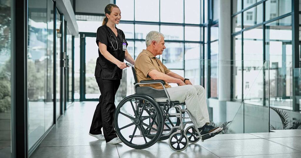 With special attention to care transitions, patients are less likely to need to return to the hospital for further care and can instead focus on their recovery at home. This image portrays a care transitions nurse helping a patient leave the hospital to receive care at home.